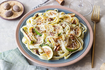 Fettuccine pasta with zucchini, nuts and parmesan cheese. Healthy eating. Vegetarian food. Italian cuisine.