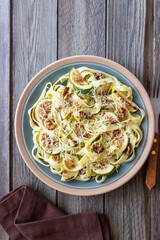 Fettuccine pasta with zucchini, nuts and parmesan cheese. Healthy eating. Vegetarian food. Italian cuisine.