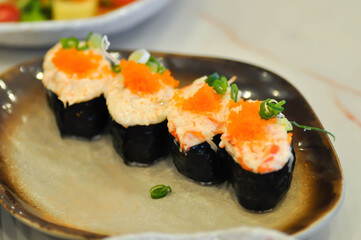maki , Japanese roll or rice roll or seaweed roll with shrimp egg topping