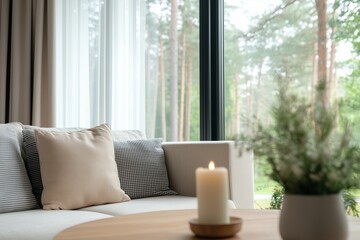 Cozy living room interior featuring a soft sofa with decorative pillows, a wooden coffee table, a lit candle, and a view of lush greenery through large windows
