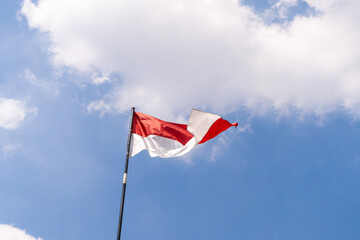 Indonesian flag in the blue sky,waving flag, indonesian Independence Day