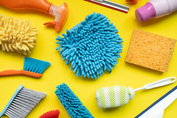 House cleaning plastic product on yellow table background, home service or housekeeping concept