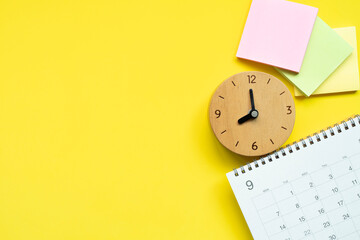 close up of calendar and clock on the yellow table background, planning for business meeting or...