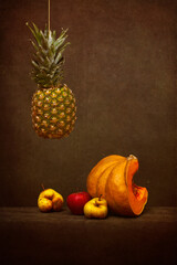Still life with pineapple, pumpkin, pears and apple