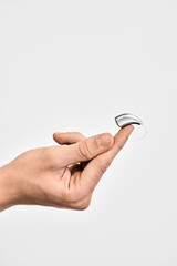 Invisible and very small behind-the-ear hearing aid for restoring patient's hearing, isolated on...