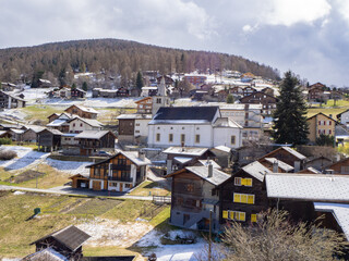 Nax, Switzerland - March 24th 2024: VIew of the historic village in front of the mountains.