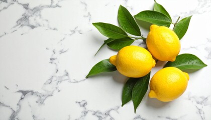 Vibrant lemons with fresh green leaves artfully arranged on a clean white marble surface