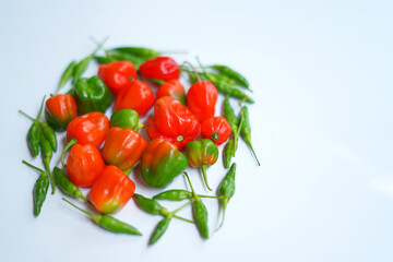 Organic Red and Green Chili Peppers on White Background – Flavorful Cooking.