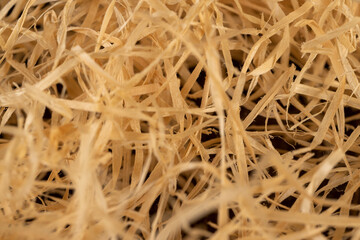 yellow sawdust from wood and for decorative and creative work of artisans or gift wrapping, close up