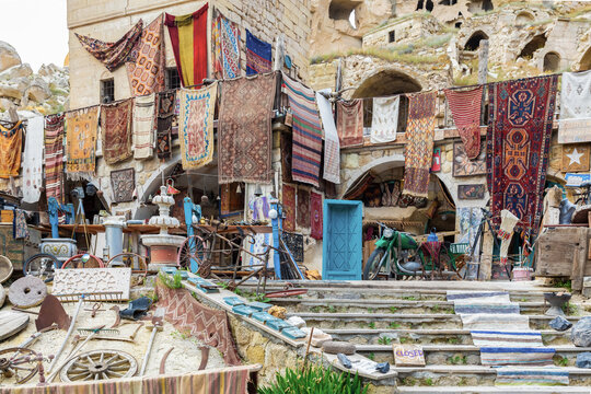 Traditional street bazaar in Cavusin, Cappadocia, Turkey with vintage carpets, antiques, and handmade crafts on display