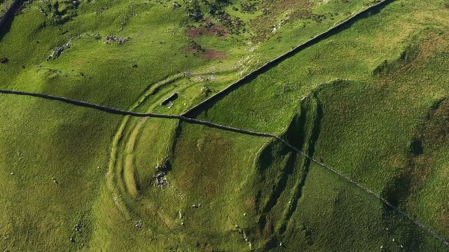 Moel Goedog prehistoric hillfort N.E. of Harlech, Wales. 2 concentric Bronze Age ramparts contain possible earlier enclosure. Video fly out up. North at 5 o&rsquo;clock
