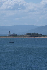 View of an island peninsula and a lighthouse