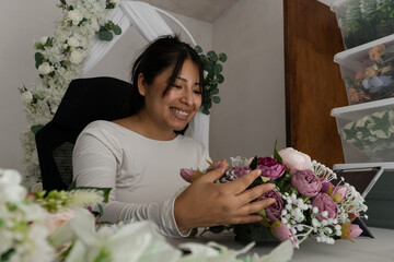 Florist arranging flowers in workshop for wedding event