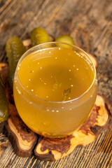 marinade in a glass and pickled cucumbers on the table, cucumbers marinated in water on the table, closeup