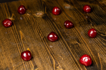 delicious ripe red cherry berries in drops of water, wet cherry fruits on the kitchen table