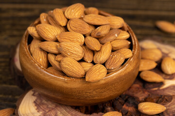 almond nuts on the table, ready-to-eat almond nuts on a wooden table, close up