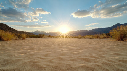 Fototapeta premium Sunset over desert landscape with golden sand and distant mountains, creating serene atmosphere