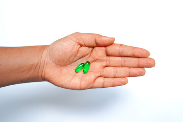 Transparent Vitamin E Capsules in Palm on White Background – Medical Stock Image.
