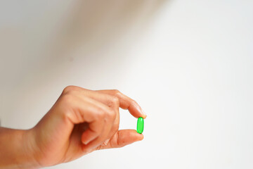 hand with a Vitamin E capsule 