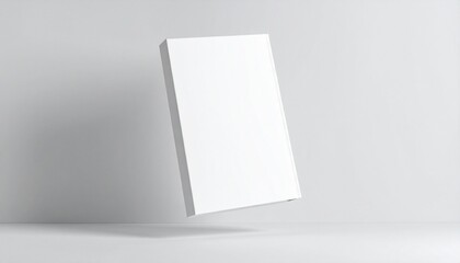 Naklejka premium A blank, white book cover mockup hovers slightly above a minimalist, light gray surface.
