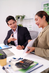 Asian business professionals collaborate discuss market data strategic planning corporate meeting modern office productive work environment sustainability initiatives