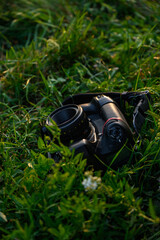 Mirror camera lying on grass, isolated photography equipment for realistic outdoor 3D presentation.