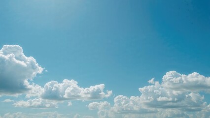 Clear azure sky dotted with white clouds creating a beautiful daytime scene