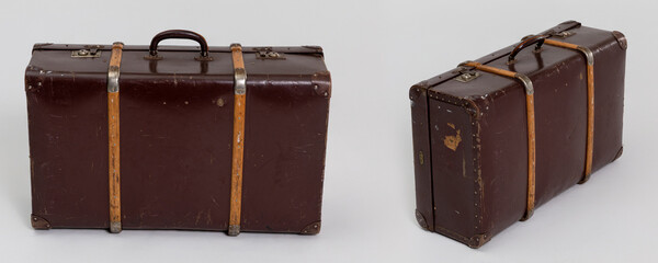 A Vintage Leather Suitcase with Brass Hardware and Wooden Straps, perfect for journeys