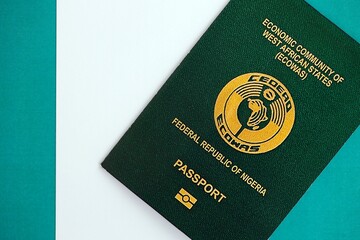 Nigerian passport on flag. The concept of citizenship