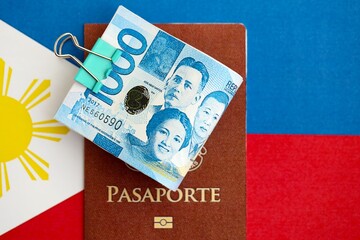 Philippines peso currency money bills and passport lies on flag. The concept of travel and vacation