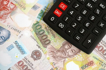 Vietnamese dong currency money bills and calculator. The concept of taxation and money count