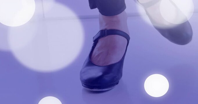 Dancer feet tapping after lifting heels, forming rhythmic heel toe pattern with light overlays