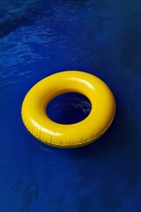A vibrant yellow swimming pool ring float gently floats on the clear blue water, creating a perfect summer atmosphere. The scene captures the essence of relaxation and fun in a warm setting