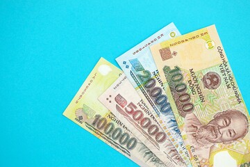 Vietnamese dong money bills in big amount on blue. Finance and banking concept