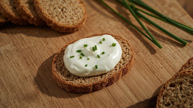 Wholegrain cracker topped with creamy quark and fresh chives
