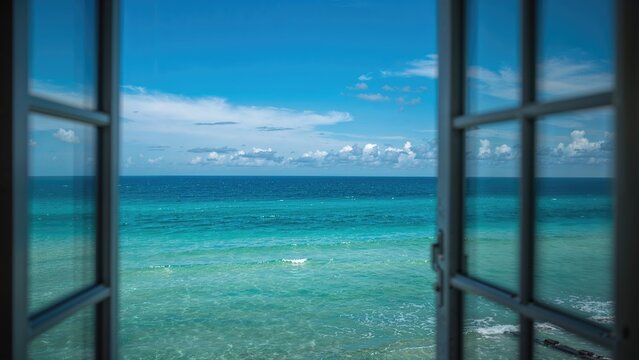 Fototapeta Ocean and sky seen through a window