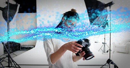 Female photographer raising DSLR as blue wave sweeping initiating shot review ensuring quality