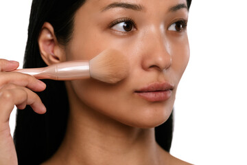 Woman Applying Makeup with a Brush for Flawless Finish