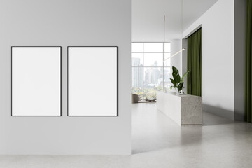 Two blank framed posters on gray wall in bright modern interior with green curtains and concrete counter in minimal design space. 3D Rendering