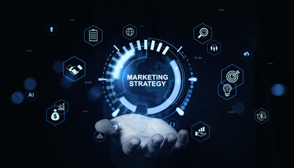 Marketing strategy concept with digital icons and holographic interface above open hand on dark background for business planning and innovation concept.