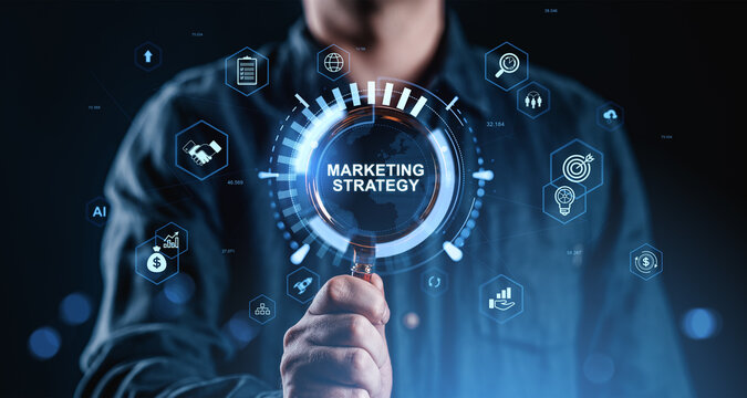 Businessman holding magnifying glass with marketing strategy hologram interface and digital business icons on futuristic dark background concept.