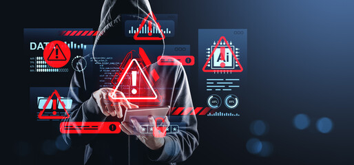 Hacker in hoodie using tablet surrounded by digital warnings and