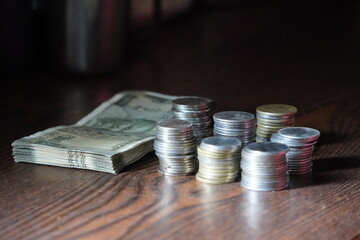 Indian Rupees, specifically a stack of banknotes and several stacks of coins. 