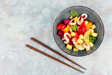 Salad with tropical fruits and shrimps.