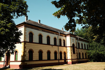 Historic yellow building with arched windows and red trim in Palic, Serbia. Captured on a sunny...