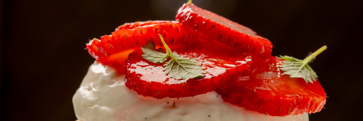 Succulent strawberries atop whipped cloud, hinting at midsummer's frolic and World Dessert Day...