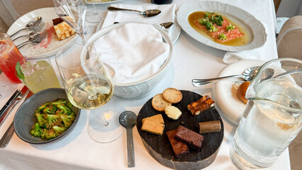 Elegant culinary mosaic of eclectic appetizers on white linen, evoking fine dining utopia, perfect for World Tapas Day celebrations