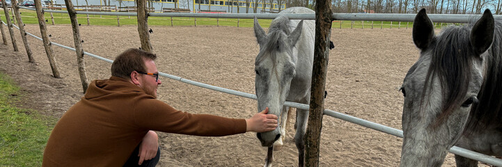 Man with gentle gaze caresses horse's muzzle, evoking pastoral tranquility, touching lives on...