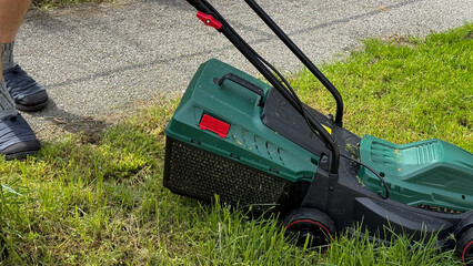 A tranquil afternoon scene of a buzzing lawnmower taming summer grass, whispering of Obon Day and Earth Day rituals
