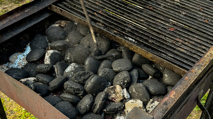 Sizzling charcoal dance, anointing rusty grill, promises smoky flavor magic, perfect for Obon or...